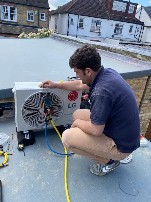 Alex performing F-Gas commissioning on a new LG split AC outdoor unit